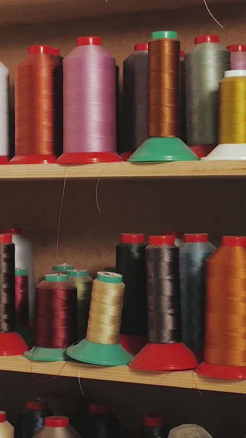 Spools of thread for sewing clothes in different colors. Spools of thread on Stock Footage 323451466