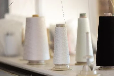 Spools of thread in the sewing equipment in fabric industry. Sewing productio Stock-Fotos