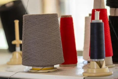 Spools of thread in the sewing equipment in fabric industry. Sewing productio Stock-Fotos