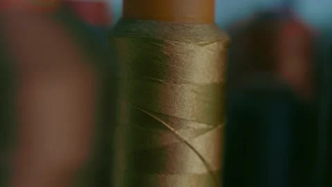 Spools of thread for sewing shoes in dark colors stand on a shelf Stock Footage 170552556