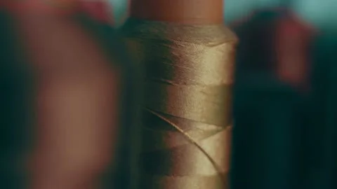 Spools of thread for sewing shoes in dark colors stand on a shelf Stock Footage 232616202