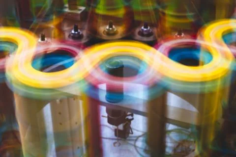 Spools of thread spin rapidly on an industrial weaving machine to weave long  Stock Photos