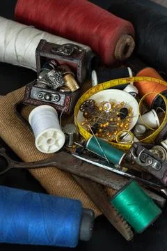 Spools of thread of various colors, Thimbles in small wooden treasure chest.. Stock Photos
