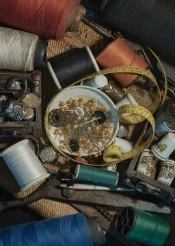 Spools of thread of various colors, Thimbles in small wooden treasure chest.. Stock Photos