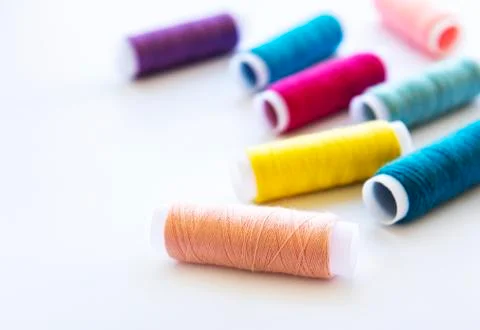 Spools of thread on a white Foto stock