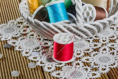 Spools of thread on a wooden background Stock Photos