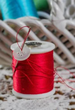 Spools of thread on a wooden background Stock Photos