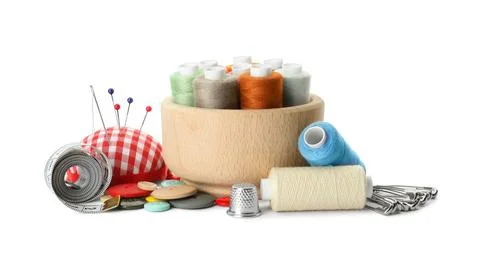 Spools of threads and sewing tools on white background Stock Photos