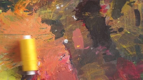 Spools of threads are rolling on painted background Stock Footage 222802238