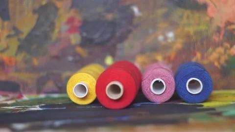 Spools of threads are rolling on painted background 스톡 동영상 222802547