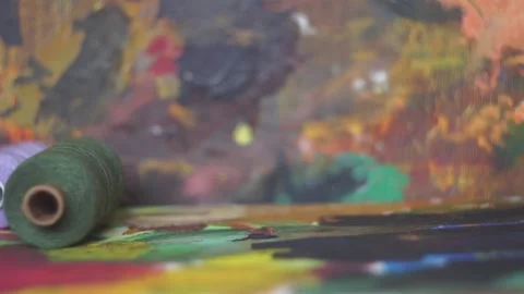 Spools of threads are rolling on painted background 스톡 동영상 222802609