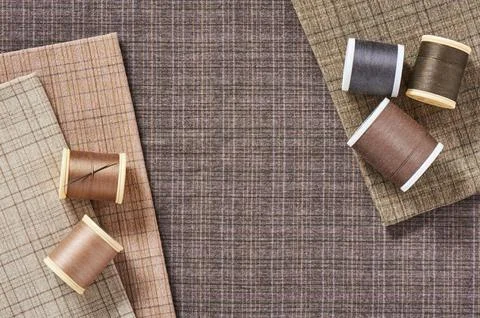 Spools of threads on checkered cotton fabric for quilting and applique Stock Photos