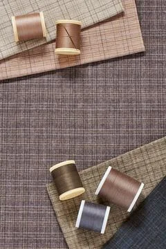 Spools of threads on checkered cotton fabric for quilting and applique Fotos de archivo