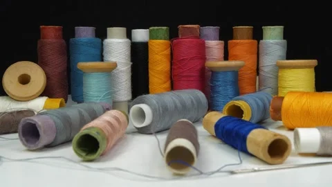 Spools with varicolored threads on black background Stock Footage 311833093