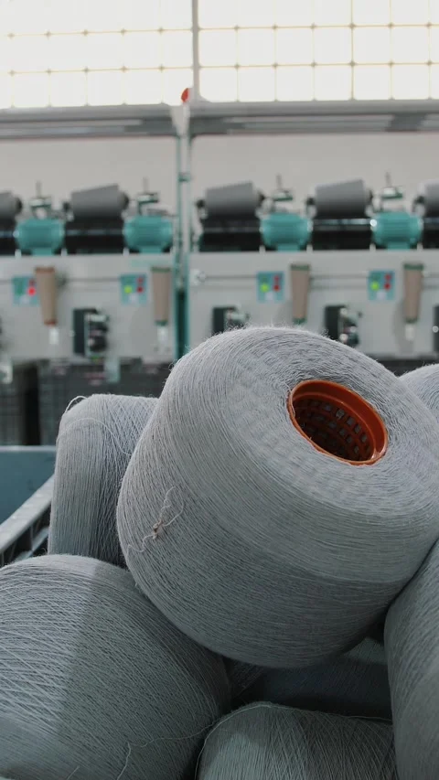 Spools of yarn thread in a basket. Textile factory equipment. Textile factory. Stock Footage 316464669