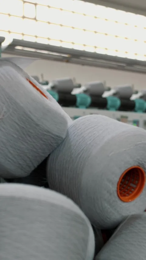 Spools of yarn thread in a basket. Textile factory equipment. Threads production Stock Footage 317940213