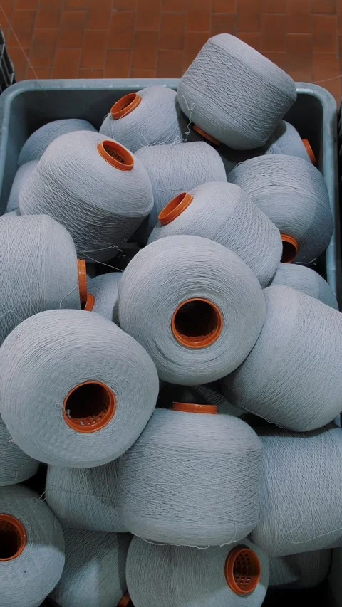 Spools of yarn thread in a basket. Threads production. Textile factory. Spinning Stock Footage 315565218