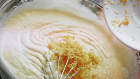 Spoon adding fragrant zest to a cake mixture, 4K Stock Footage 341117903