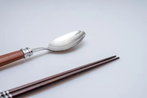 Spoon and chopsticks concept Stock Photos