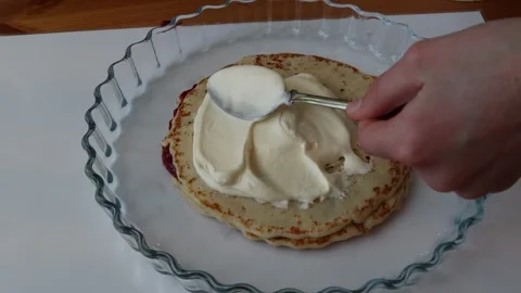 Spoon and cream with pancake. Stock Footage 256105325