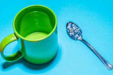 Spoon and cup with microplastics Stock Photos