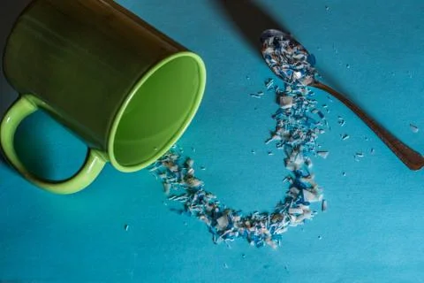 Spoon and cup with microplastics Stock Photos