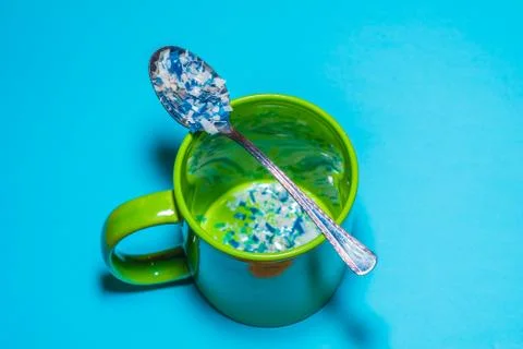 Spoon and cup with microplastics Stock Photos