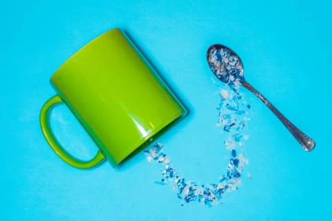Spoon and cup with microplastics Stock Photos