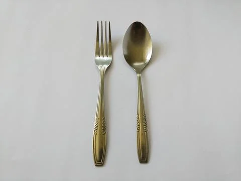 Spoon and fork arranged parallel Stock Photos