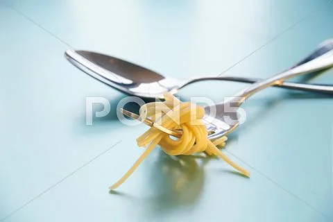 Spoon and fork with spaghetti Stock Photos