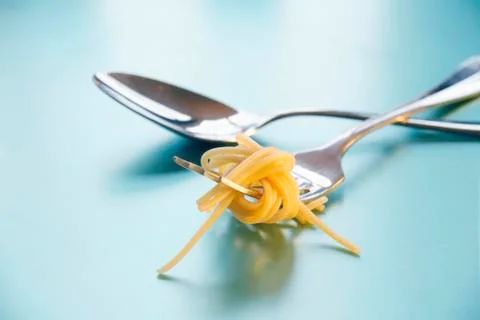 Spoon and fork with spaghetti Stock Photos