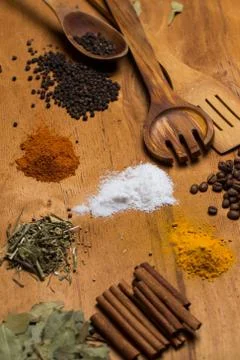 Spoon and heap of spices on the table Stock Photos