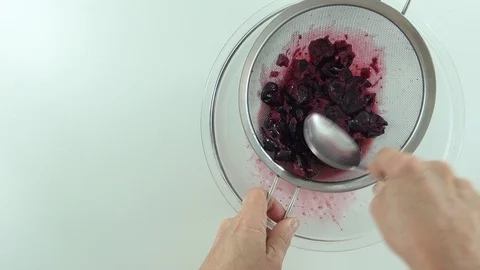 With spoon and sieve, preparing jam and sifting jaboticaba or jaboticaba. Stock Footage 128820854