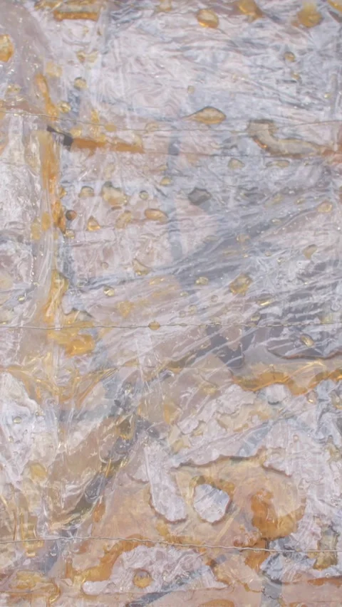 Spoon and spatula sampling amber honey on glossy surface with wood edge, with Stock Footage 344583040