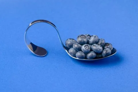 Spoon with blueberries Stock Photos