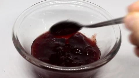 A spoon in a bowl of cherry jam Stock Footage 190011164