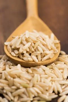 Spoon of brown rice close up Stock Photos