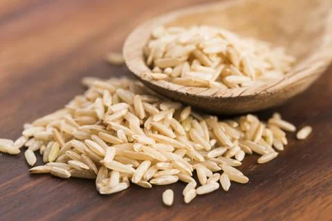 Spoon of brown rice close up Stock Photos
