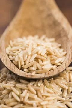 Spoon of brown rice close up Stock Photos