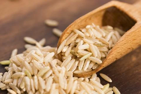 Spoon of brown rice close up Stock Photos
