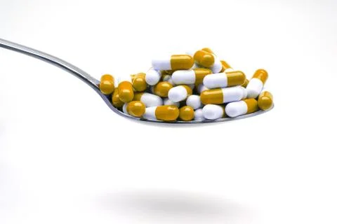 Spoon with capsulas Stock Photos