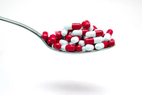 Spoon with capsules Stock Photos