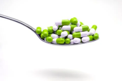 Spoon with capsules Stock Photos
