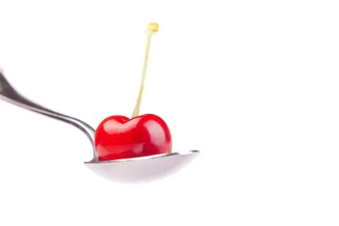 Spoon with cherry Stock Photos