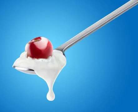Spoon of cherry yogurt Foto stock