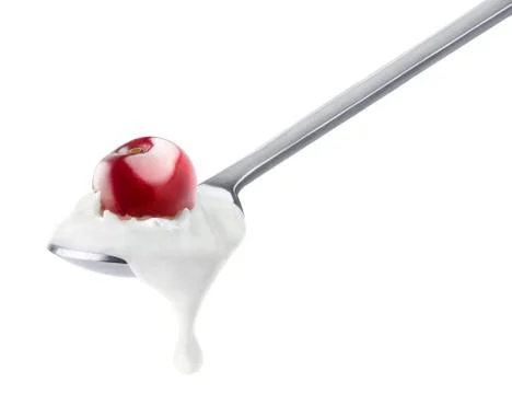 Spoon of cherry yogurt Foto stock