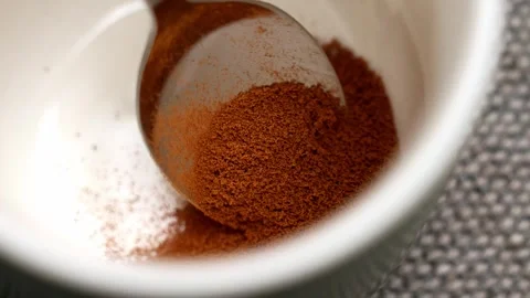 Spoon with chicory powder falling into an ceramic mug Stock Footage 332732256