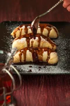 Spoon with chocolate glaze and plate with puffs Stock Photos