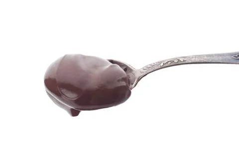 Spoon with chocolate pudding close up on white background Stock Photos
