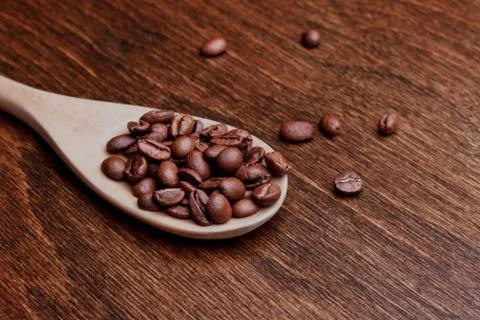 Spoon with coffee beans Stock Photos